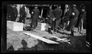 View of soldiers nailing coffins shut in France during World War I, ca.1916