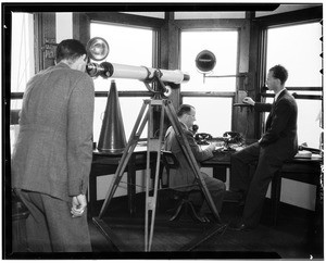 Three men in an observation room at the Marine Exchange, ca.1920-1929
