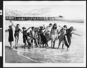 Women and children lined up in the surf, ca.1920