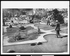 People playing golf on a miniature golf course, ca.1930