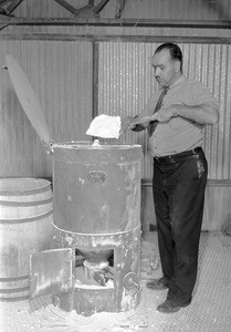 Man shoveling a white substance