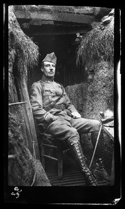 Soldier sitting in a chair in a trench during World War I, ca.1916