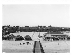 Small homes and businesses on Ocean Park beach at the pier, ca.1900