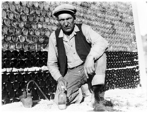 Man in front of a wall of bottles