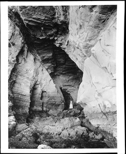 Woman standing in Mamoth Cave at Point Loma in La Jolla, ca.1905