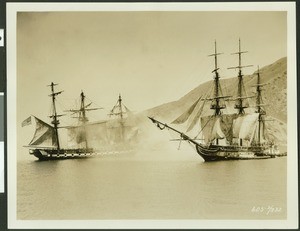 "Old Ironsides" replica in a staged sea battle used for a motion picture, showing small village in background completely obscured by smoke, ca.1926