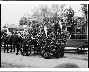 Group of men in a horse-drawn float in the Pasadena Tournament of Roses Parade, ca.1900-1910