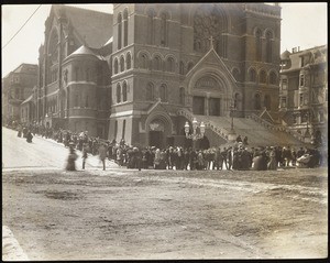 Refugees standing in a bread line in front of a Roman Catholic Church on Van Ness Avenue, San Francisco, 1906