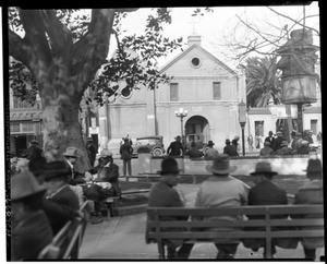 Men seated on benches near the Plaza Church, Los Angeles, ca.1910