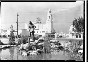 Exterior view of the Circle Theater showing a statute of a gold miner in the foreground