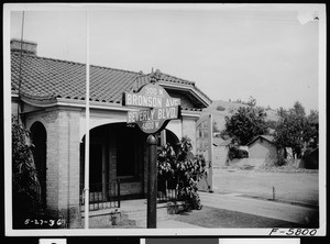 New street signs for Bronson Avenue and Beverly Boulevard outside a fire station, 1936