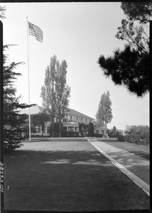 Exterior view of a country club in Los Angeles, showing a flag waving, October, 1934