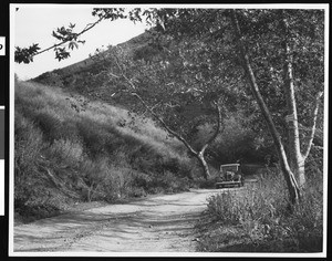 Automobile driving on a road in Pole Canyon near Fillmore, Ventura County, ca.1930