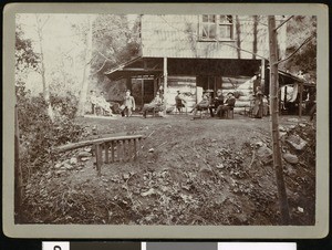 A group of fishing club members outside a mountain residence, ca.1910-1920