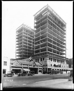 Exterior view of the Pacific Finance Building (Heron Building) being built northwest of the intersection of Olive Street and Sixth Street, August 30, 1925