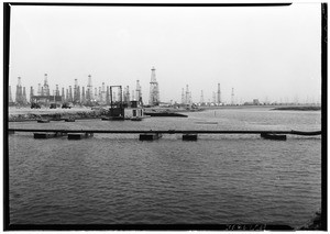 View of oil fields and a dredger at the channel for the Rowing Stadium site for the Olympics, January 23, 1932