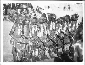 Snake priests chanting songs and swinging eagle feathers during a Snake Dance Ceremony at Oraibi, Arizona, ca.1896