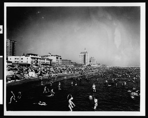 Crowds in the water at Long Beach looking east from just east of Municipal Auditorium, ca.1930