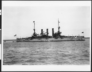 Starboard view of the U.S.S. Connecticut with several smaller boats alongside, 1908