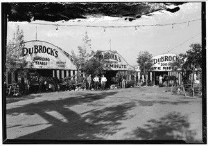 DuBrock's Boarding Stable, showing three barns and several horses