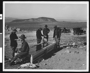 Five people stopping for water at Granite Wells, Death Valley, ca.1900-1950