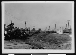 View of a railroad yard looking west from St. James Street, showing what may be a water-flow channel