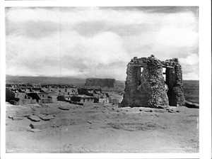 View of the pueblo of Acoma from the roof of the old church showing the bell tower and Mesa Encantada, ca.1896