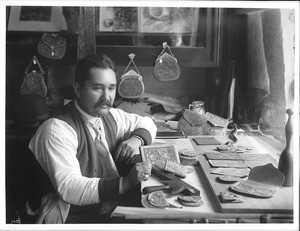 Mexican worker of carved leather in his shop, ca.1905