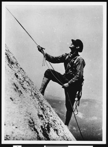 A mountain hiker climbing Half Dome at Yosemite National Park, ca.1930