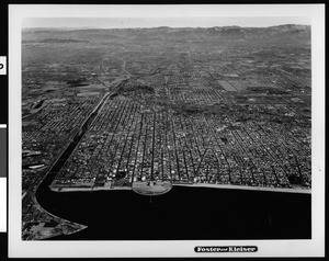 Aerial view of Long Beach looking north over the city from the ocean, December 8, 1955