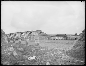 Central courtyard of the Mission San Juan Capistrano, showing crumbling arches, ca.1895