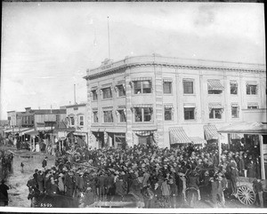 View of hundreds of people gathering in front of the Mining Stock Exchange building, Goldfield, Nevada, ca.1906