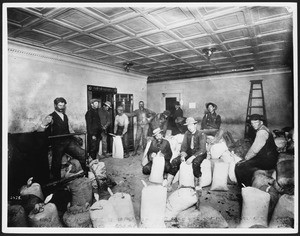 Hayes and Monnette (?) sacking high-grade ore for deposit in Cook's County Bank, Goldfield, Nevada, ca.1905