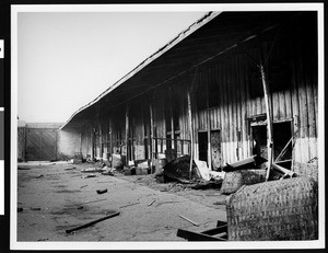 Trash strewn behind a gated building in old Chinatown, 1939