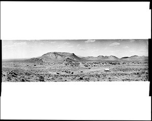 Panoramic view of Rhyolite, Nevada, showing hills in the distance, ca.1900