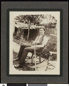 Portrait of a man seated in a rocking chair outdoors