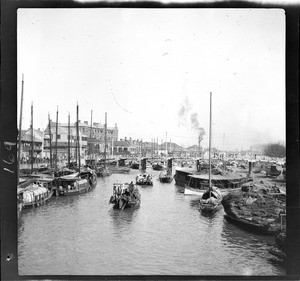 River boats making their way towards a bridge in Shanghai, ca.1900