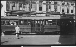 Street trolley car passing a street corner, ca.1930