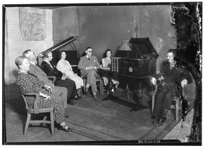 Group of blind people sitting around listening to a "talking book", ca.1928