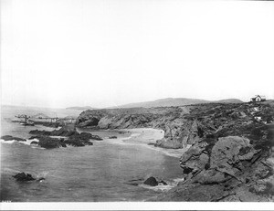 Rocky banks encroach on a beach in Newport Bay, viewed from the south, ca.1905