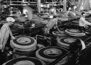 Workers monitoring tire molds at an unidentified Los Angeles factory