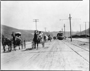 Carriages and street cars moving west along Sunset Boulevard on Tunnel Day, Los Angeles, September 15, 1909