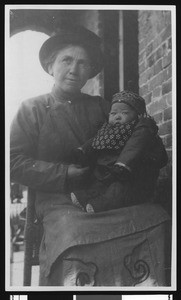 Portrait of a woman named Cameron holding a Chinese baby, ca.1900