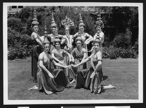 Elaborate costumed dancers posing for a photographer, ca.1930