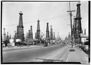 View of Long Beach Boulevard passing through Signal Hill, showing an oil field, ca.1933