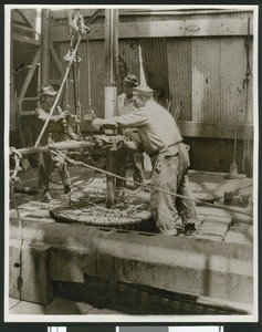 Men working in the "operating room" of the Nasa Well Number 11 in the Signal Hill oil field near Long Beach, ca.1940