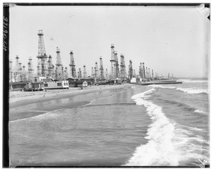 Waves crashing on a beach near an oil field in Playa del Rey