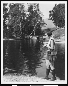 Woman fishing at Rainbow Angling Club, Azusa, ca.1930