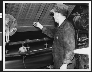 Man taking part in the tire-making process at the B.F. Goodrich Company, ca.1950