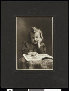 A portrait of a young girl with a book